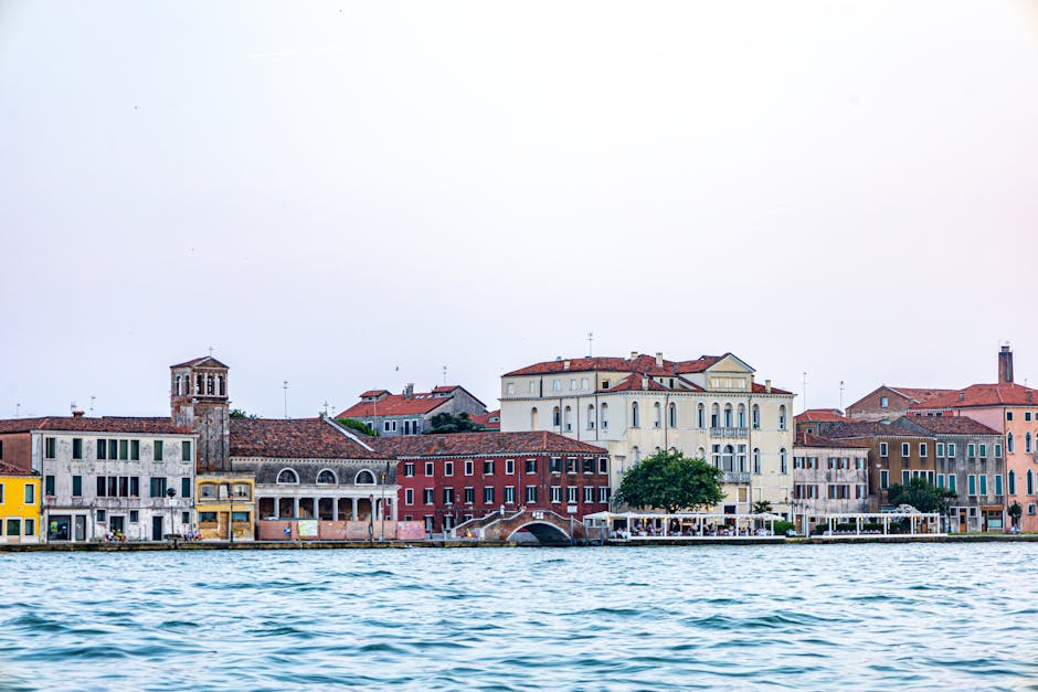 Charming Venetian buildings by the waterfront during the day, capturing classic architecture.
