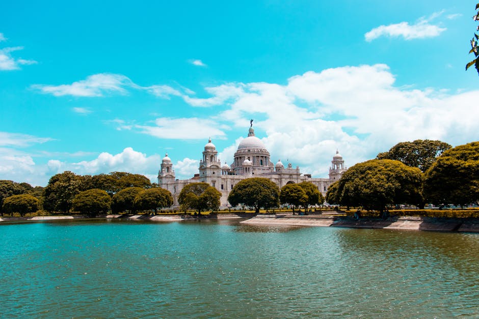 Captivating view of the Victoria Memorial in Kolkata, India with a serene lake in the foreground.