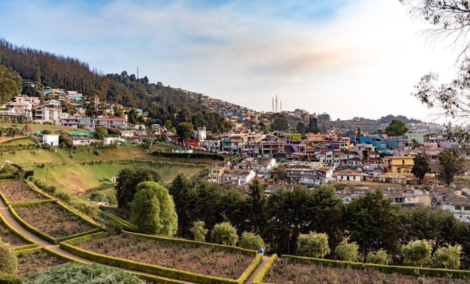 Charming view of Ooty town nestled in lush hills under a clear sky.