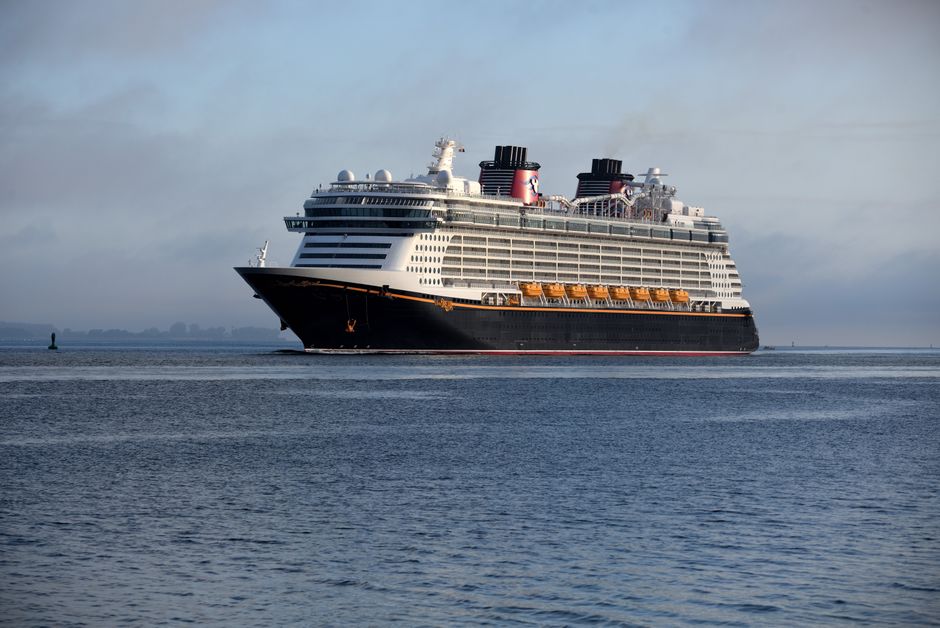 A majestic cruise ship gracefully navigates the serene ocean waters, epitomizing luxury travel.