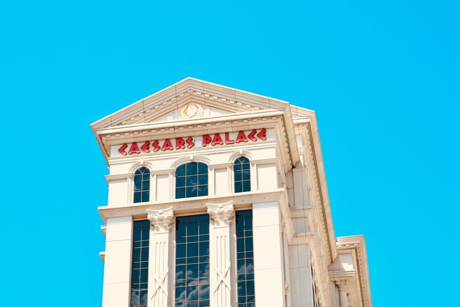 Elegant facade of Caesars Palace against a vibrant blue sky.