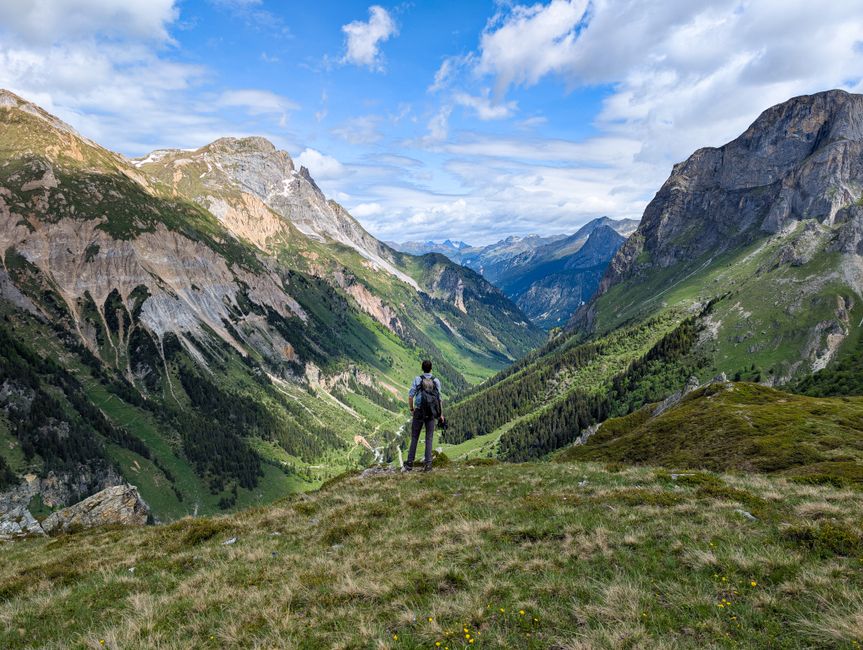 A hiker stands in awe of the scenic Vanoise National Park in France.