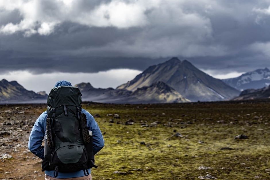A lone backpacker hiking through Iceland's dramatic and picturesque highlands.