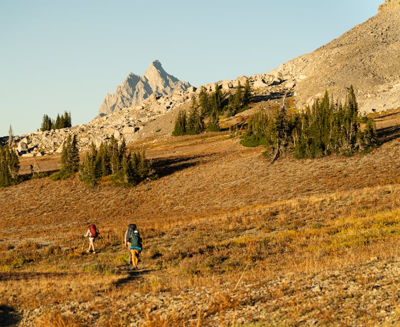 Two hikers on the Teton Crest Trail at Grand Teton National Park during fall season.