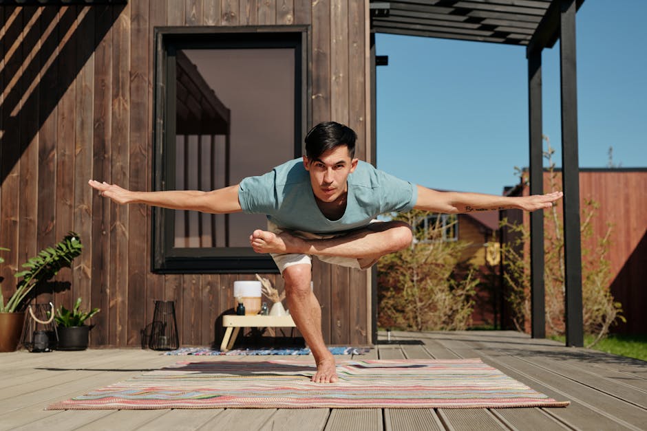 A man performing a yoga pose on a veranda outside, embracing a balanced and healthy lifestyle.