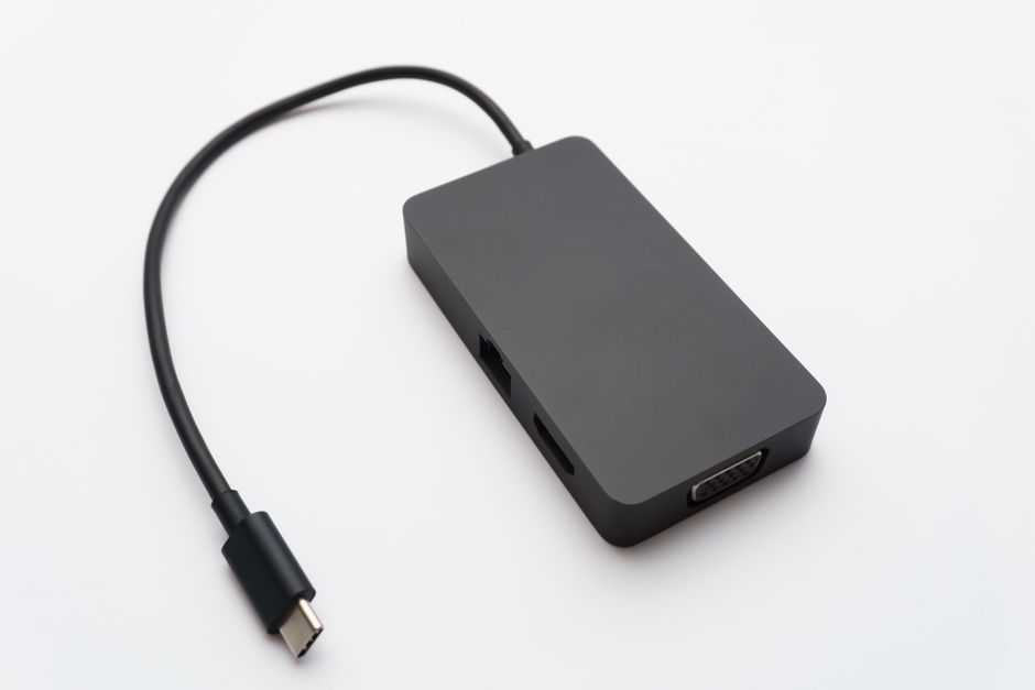 Sleek USB-C hub with HDMI, USB, and Ethernet ports on white background.