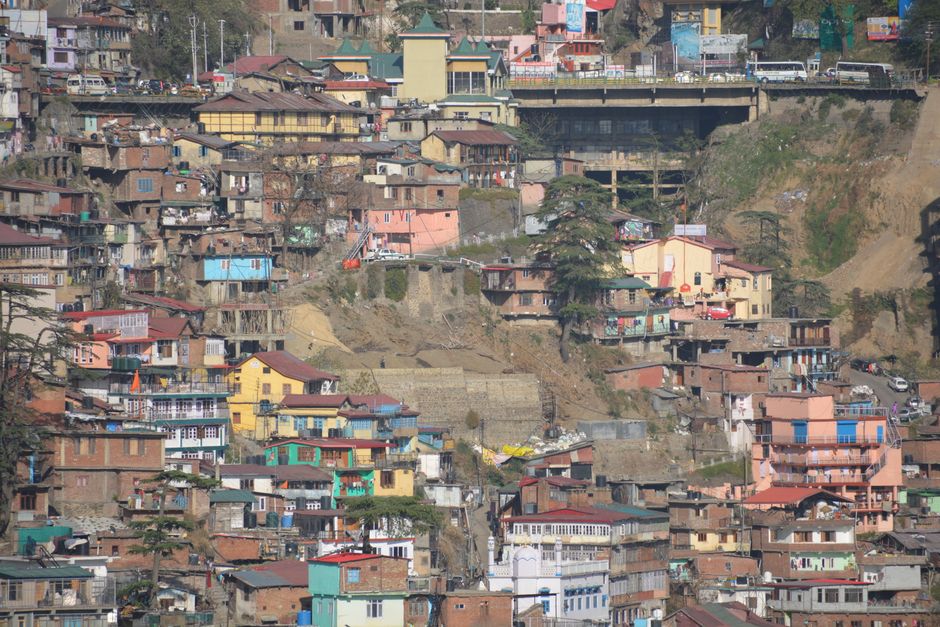 Vibrant hillside architecture in Shimla, highlighting colorful homes and urban density.