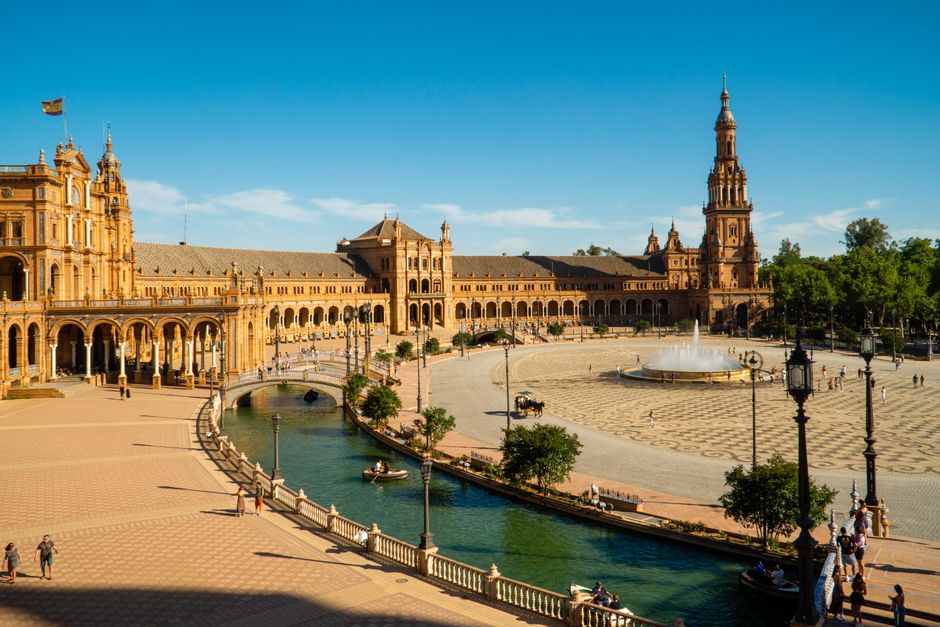 Captivating aerial view of the historic Plaza de España in sunny Seville, Spain.