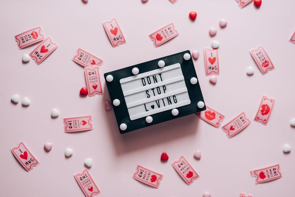 Letter board with 'Don't Stop Loving' surrounded by heart-shaped tickets and candies.
